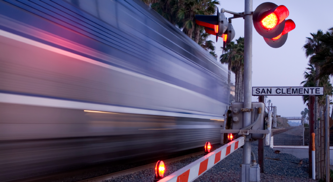 Train crossing with train passing by